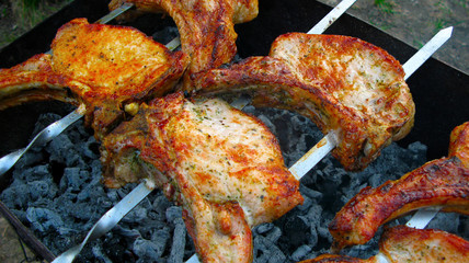BBQ  meat on barbecue. Grilled kebab cooking on metal skewer.