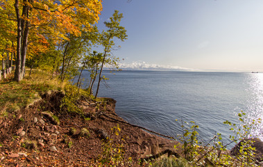 Autumn On Lake Superior. Fall foliage lines the rocky coast of Lake Superior at Presque Isle Park in Marquette, Michigan.