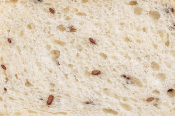 Texture of sliced wheaten bread with flax seed. Flat lay, top view, close-up. Copy space