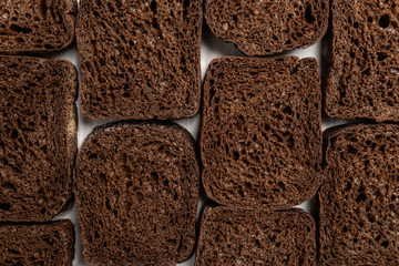 Pattern of sliced rye bread pieces. Flat lay, top view, copy space