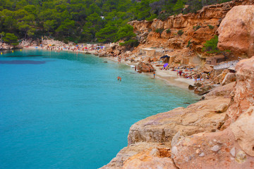 Fototapeta na wymiar cliff, beach on the coast and sea of ​​Cala Saladeta on a cloudy day