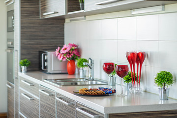 Close-up of kitchen set. Surface with sink. Decorative elements.