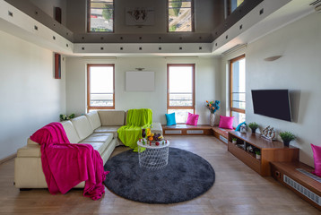 Modern interior of living room. Cozy sofa. Food and drinks. Wooden sills.