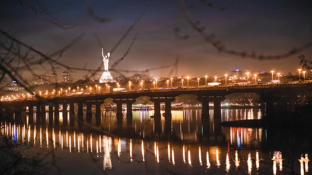 Time laps, view of the Paton Bridge over the Dnieper River in Kiev in late spring in early spring, thick clouds, snow