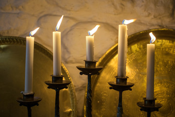 Golden candelabrum or candle chandelier with light candles. Traditional antique lighting system.