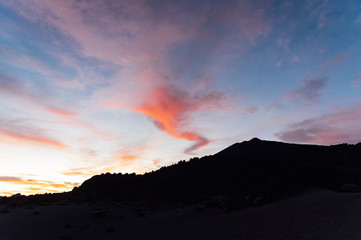 camera movement over the tops of the mountains with a beautiful sunset