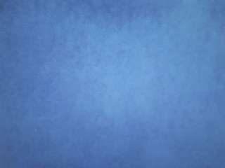  close-up of a decorative wall with bokeh effect and characteristic rough porous texture, abstract dark and light spots on a classic blue background