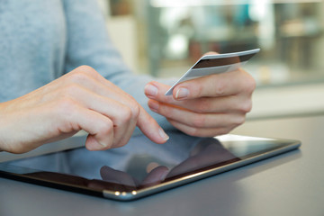 young person using digital tablet, cashless shopping and buying with credit card, horizontal