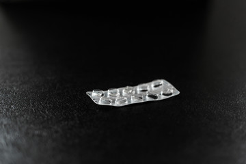 Empty blister from pills lies on the table