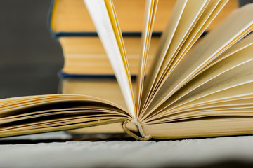Open book, hardback books on wooden table. Back to school. Copy space