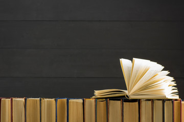 Open book, hardback books on wooden table. Back to school. Copy space