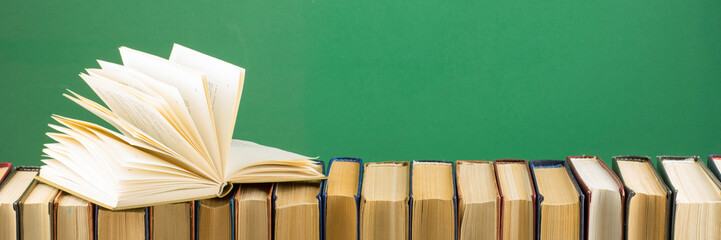 Open book, hardback books on wooden table. Back to school. Copy space