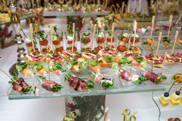 Catering. Off-site food. Buffet table with various canapes, sandwiches, hamburgers and snacks.