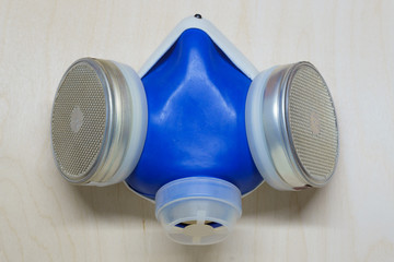 Blue gas mask on wooden desk