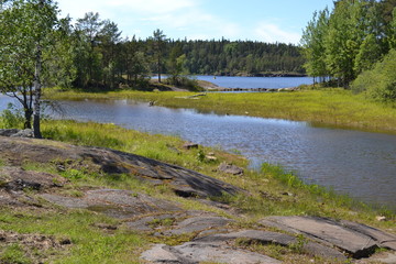 The rocky coast on the island of Valaam. Nice view of the lake and forest.