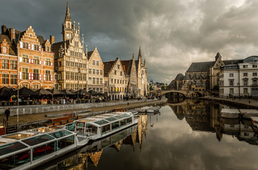 Naklejka na ściany i meble Graslei quay in the historic city center of Ghent, with boats bridge and old flemish buildings, Belgium