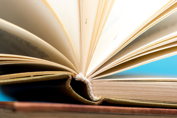 Open book, hardback books on wooden table. Back to school. Copy space.