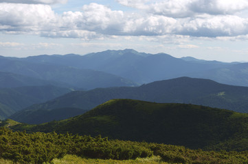 Beautiful mountain landscape, with mountain peaks covered with forest and cloudy sky.Ukrainian Carpathian Mountains