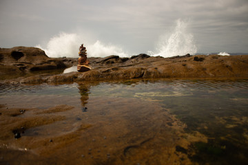 Rock stack against breaking waves