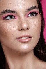 face of a beautiful girl close-up. cosmetics, makeup, freckles