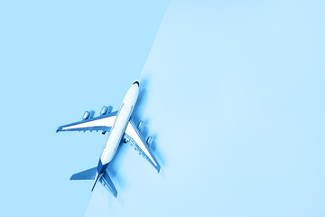 Naklejka na ściany i meble Minimal layout with model airplane on classic blue background.