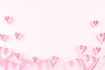 Pink paper hearts on Light pink pastel paper background. Love and Valentine's day concept.