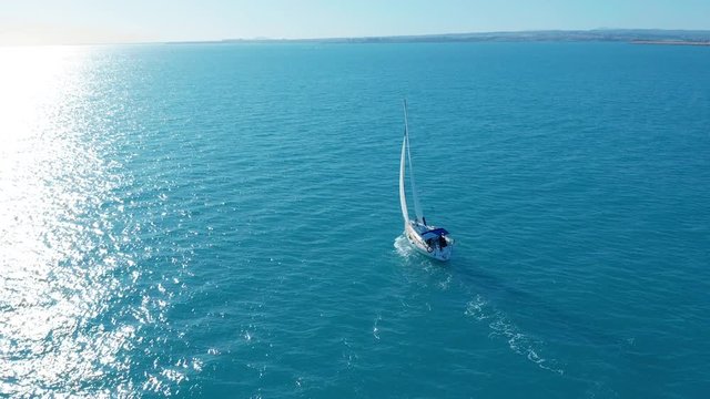 Aerial view. Traditional yacht sailing across sea.