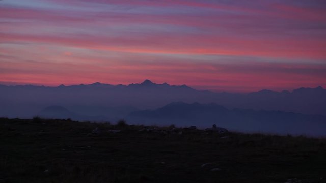 Amazing sunset (sunrise) in the alpse dolomities with pink clouds and blue hues in the mountain peaks
