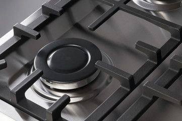 The hob burner on a stainless steel gas stove