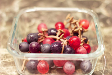 box for food storage in the refrigerator. artificial grapes