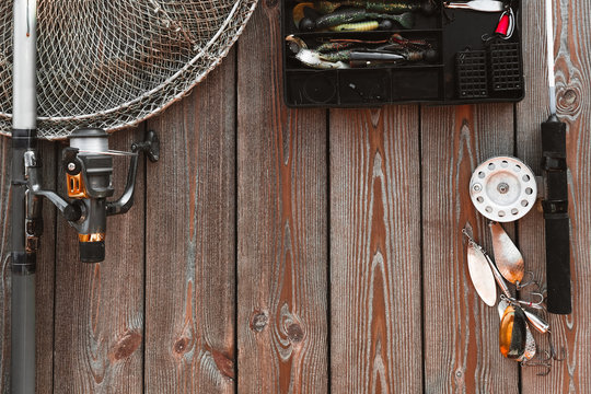 fishing rods and tackles on the wooden background