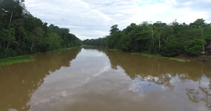 Larger River Between a Lot of Vegetation in the Amazon Rainforest with Tiny House in Pando / Bolivia