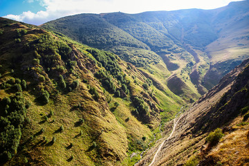 The path to the temple and stream in the mountains of Georgia near Mount Kazbek