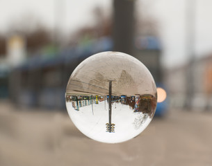Fototapeta na wymiar Straßenbahn durch eine Kristallkugel fotografiert 