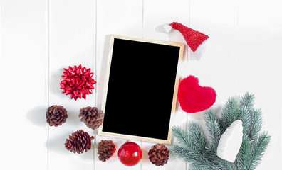 Christmas frame composition, black chalkboard, red ribbon, pine cones, white wooden background, flat lay, top view, copy space for banner, End year sale, discount or shopping promotion advertising