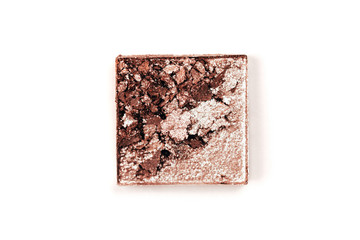Brown crushed eyeshadows with shimmer. Cosmetics concept. Flat lay style.