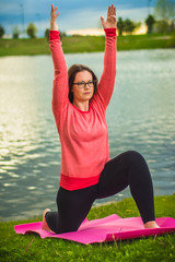 young woman doing yoga exercises in the park