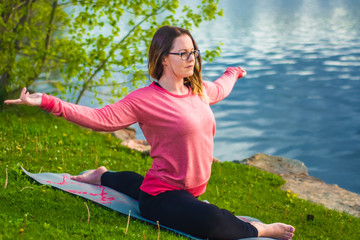 young woman doing yoga in park