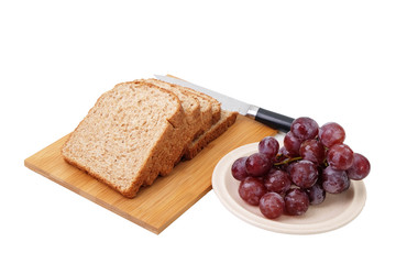 Whole grain bread and grapes isolated on white background..