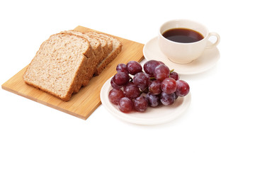 Whole grain bread and grapes serve with a cup of coffee isolated on white background..