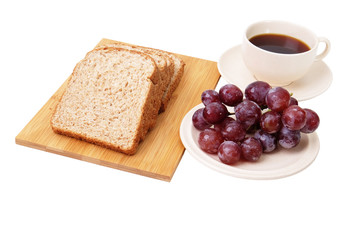 Whole grain bread and grapes serve with a cup of coffee isolated on white background..