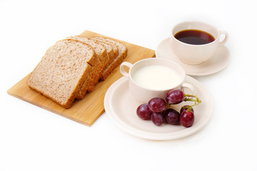 Whole grain bread, grapes and milk serve with a cup of coffee..