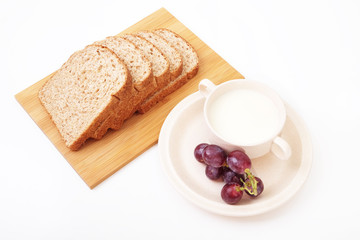 Whole grain bread and grapes serve with milk..