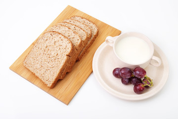 Whole grain bread and grapes serve with milk..