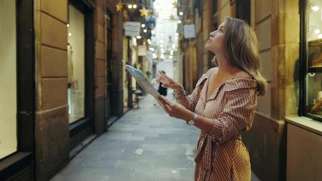 Side view of focused woman looking map outdoor. Tourist woman searching address