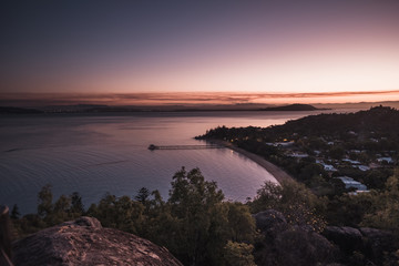 Fototapeta premium Magnetic island, Australia: view on the bay from the Hawkings point track during sunset, beautiful colourful pink sky