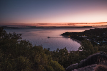 Fototapeta na wymiar Magnetic island, Australia: view on the bay from the Hawkings point track during sunset, beautiful colourful pink sky