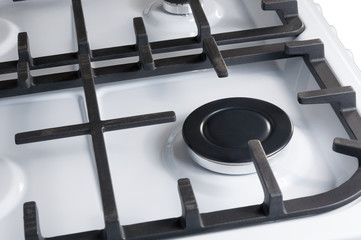 The hob burner is on a white gas stove