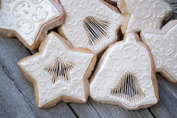 Christmas cut out cookies decorated in royal icing on wooden table