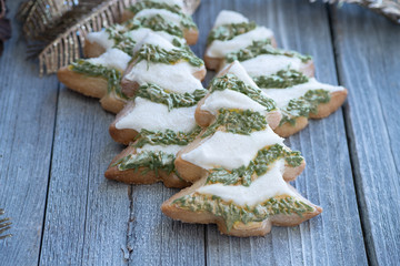 Christmas; tree cut out cookies decorated in royal icing on wooden table